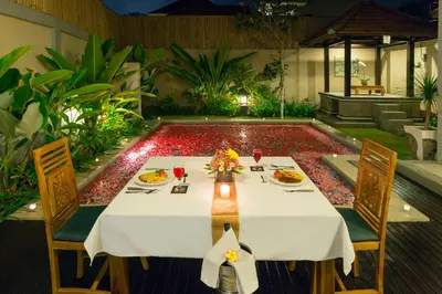 a table with plates of food on it in a restaurant at Kubal Villa and Living Seminyak in Canggu