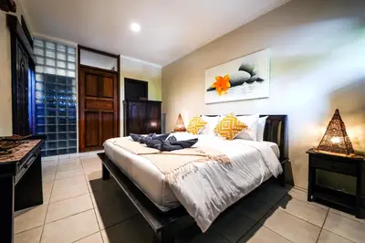 a bedroom with a large bed in a room at Villa LOGAN - KUTA - 5 Bedroom - 3 Bathroom Villa - Great Location in Kuta