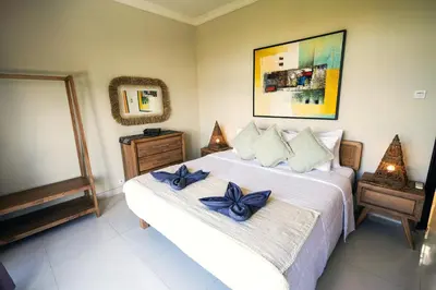 a bedroom with a bed with blue bows on it at Villa LOGAN - KUTA - 5 Bedroom - 3 Bathroom Villa - Great Location in Kuta