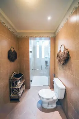a bathroom with a toilet and a shower at Villa LOGAN - KUTA - 5 Bedroom - 3 Bathroom Villa - Great Location in Kuta