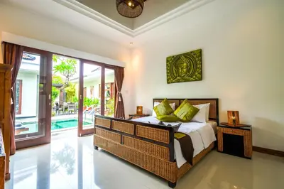 a bedroom with a bed and a sliding glass door at Villa VINO - LEGIAN - 3 bedroom - 3 bathroom Villa - Great Location in Seminyak