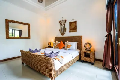 a bedroom with a bed and a mirror at Villa VINO - LEGIAN - 3 bedroom - 3 bathroom Villa - Great Location in Seminyak