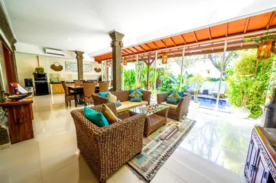 a living room with wicker chairs and a table at Villa CONOR - LEGIAN - SEMINYAK - 2 Bedroom 2 Bathroom Villa - Great Location in Seminyak