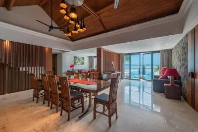 a dining room and living room with a table and chairs at New Villa Selamanya in Ujung
