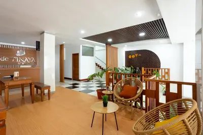 a lobby with chairs and tables in a building at Cove De Tinaya in Legian