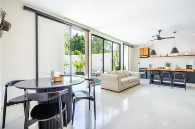 a kitchen and living room with a table and chairs at The R Villa Kaba - incl. Motorbikes in Seminyak