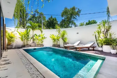 a swimming pool in the backyard of a house with plants at The R Villa Kaba - incl. Motorbikes in Seminyak