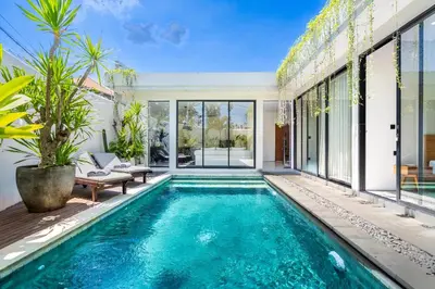 a swimming pool in a villa with a house at The R Villa Kaba - incl. Motorbikes in Seminyak