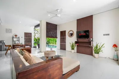 a living room with a couch and a table at The R Villa Toba - incl. Motorbikes in Seminyak