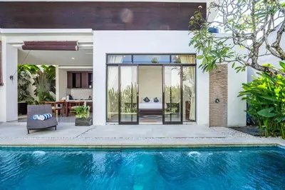 an external view of a house with a swimming pool at The R Villa Toba - incl. Motorbikes in Seminyak
