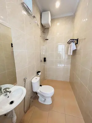 a bathroom with a toilet and a sink at James Guest House in Seminyak