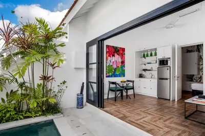 an open kitchen and living room with a sliding glass door at Villa Balik I Seminyak in Seminyak