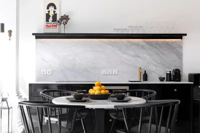 a table with chairs and a bowl of oranges on it at Martini Beachside Villa 1 in Canggu