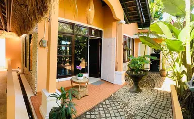 a house with a courtyard with plants in it at Giri's Villa Jimbaran in Jimbaran