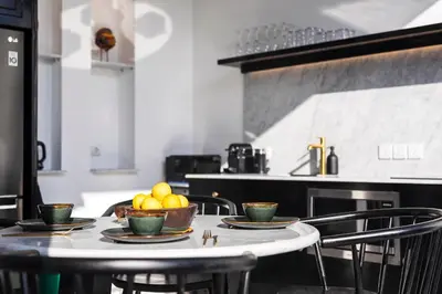 a table with plates and bowls of fruit on it at Martini Beachside Villa 3 in Canggu