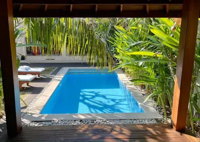a swimming pool in a yard with plants at Villa Majegau 2 Seminyak in Seminyak