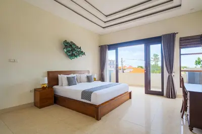 a bedroom with a bed and a large window at Villa Maxima by Maheswara in Canggu