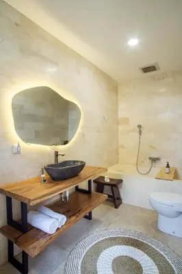 a bathroom with a sink and a bath tub at Villa Maxima by Maheswara in Canggu