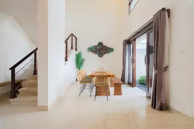 a dining room with a table and chairs at Villa Maxima by Maheswara in Canggu