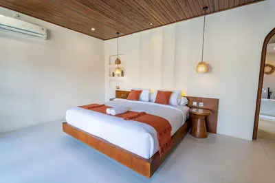 a bedroom with a large bed in a room at Green Jimbaran Bay Villa in Jimbaran