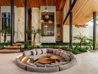 a living room with a couch and a table at Can Maestro Bali by House of Winds - Lush Sanctuary near Canggu in Kerobokan