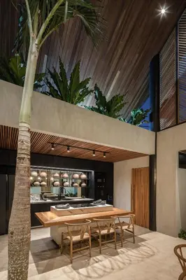 a dining room with a table and a palm tree at Can Maestro Bali by House of Winds - Lush Sanctuary near Canggu in Kerobokan