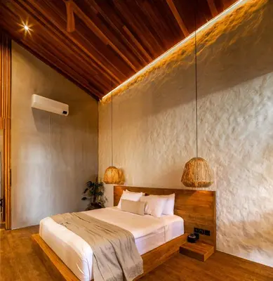 a bedroom with a large bed with two lamps at Can Maestro Bali by House of Winds - Lush Sanctuary near Canggu in Kerobokan