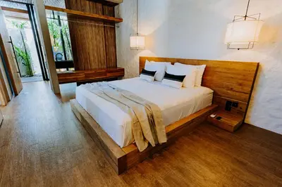 a bedroom with a large bed in a room at Villa FEH Bali by House of Winds - Neo Tropical Eden near Canggu in Kerobokan