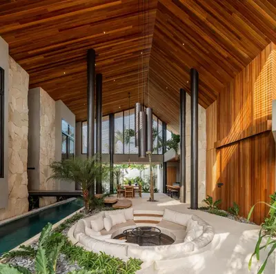 an indoor courtyard with a pool and a large wooden ceiling at Villa Levante Bali by House of Winds - Tropical Oasis near Canggu in Kerobokan