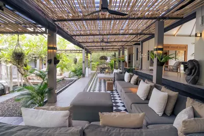 an outdoor living room with couches and a pergola at Sin Nombre Bali - Sauna, Ice Bath & Roof Terrace in Canggu