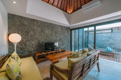 a living room with a couch and a tv at Villa Kalila: Elegant 2 BR Villa in Perfect Location ! in Seminyak