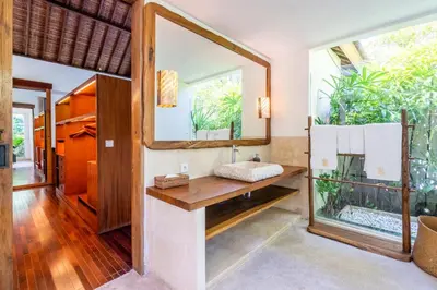 a bathroom with a sink and a mirror at Villa Ku Besar by Villa Finder in Dalung