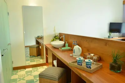 a bathroom with a sink and a mirror at The Open House Jimbaran Bali in Jimbaran