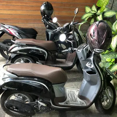 two motorcycles parked next to each other with a helmet at The Open House Jimbaran Bali in Jimbaran