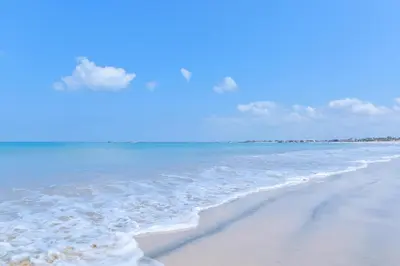 a beach with the ocean and the sky at The Open House Jimbaran Bali in Jimbaran