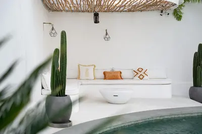 a living room with a bench and a cactus at Villa Weiss Berawa in Canggu