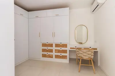 a dressing room with a mirror and a chair at Villa Weiss Berawa in Canggu