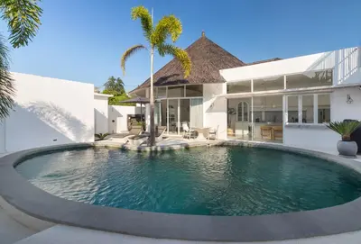 a swimming pool in front of a house at Villa Weiss Berawa in Canggu