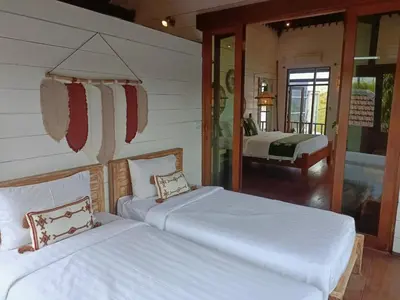two white beds in a room with a bedroom at Villa Nicole 5BR Paradise, quiet area in Central Oberoi Seminyak in Seminyak