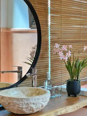 a bathroom sink with a mirror on top of a counter at Villa Nicole 5BR Paradise, quiet area in Central Oberoi Seminyak in Seminyak