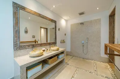 a bathroom with two sinks and a mirror at Villa Harlow: Stylish 3BR Villa - Centrally Located in Berawa in Canggu