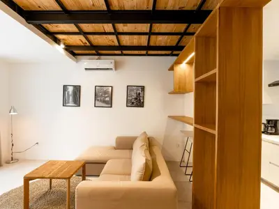 a living room with a couch and a table at Berawa Village Suite in Canggu