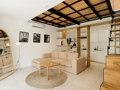 a living room with a couch and a table at Berawa Village Suite in Canggu