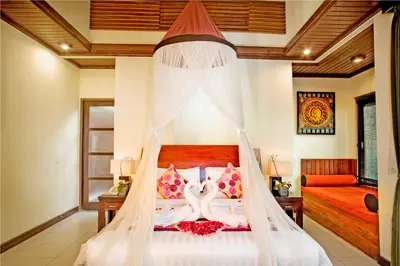 a bedroom with a bed with two swans on it at The Bali Dream Suite Villa Seminyak in Seminyak