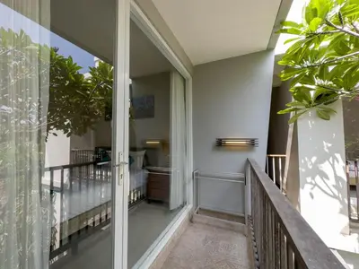 a corridor of a house with a balcony at Hola Seminyak in Seminyak
