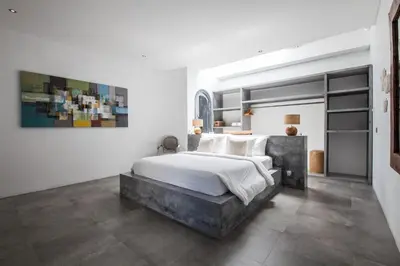 a bedroom with a large bed with white sheets at Villa Xaloc by House of Winds - Stunning Balinese retreat next to Canggu in Kerobokan