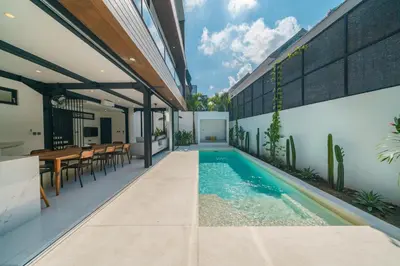 an external view of a house with a swimming pool at Villa Vantage 7 - Outstanding 3 BR Villa - Great Location! in Canggu