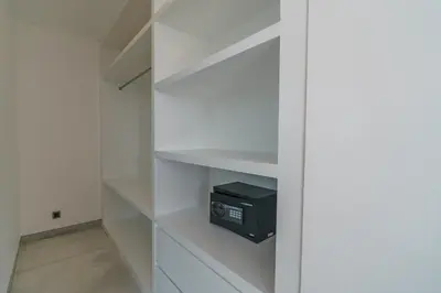 a walk in closet with a white cabinet with a computer system at Villa Vantage 7 - Outstanding 3 BR Villa - Great Location! in Canggu
