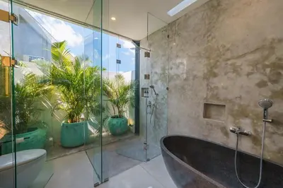 a bathroom with a tub and a toilet and plants at Villa Vantage 7 - Outstanding 3 BR Villa - Great Location! in Canggu