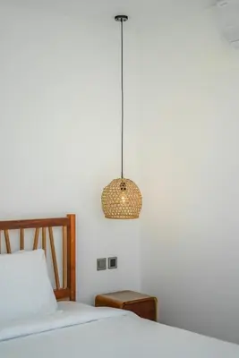 a bedroom with a bed and a pendant light at Villa Vantage 7 - Outstanding 3 BR Villa - Great Location! in Canggu